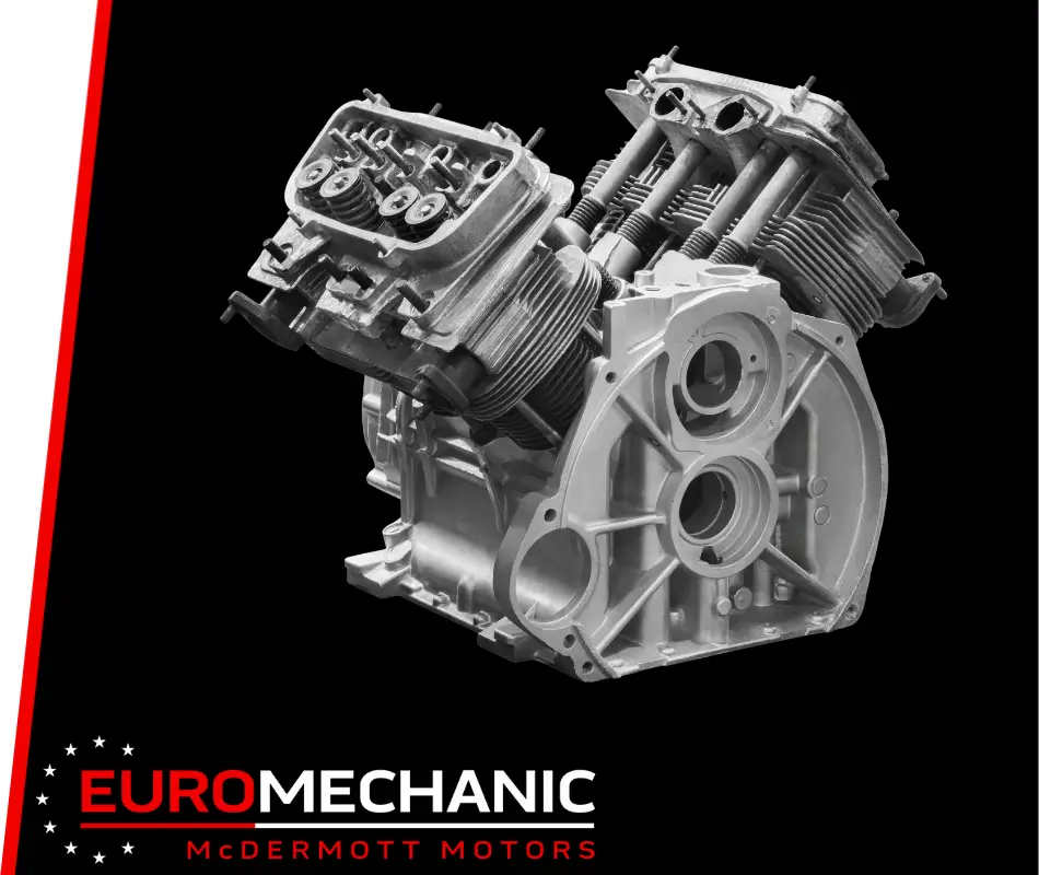 A black and white image of a motorcycle engine against a black background showcases visible cylinders and pistons. EUROMECHANIC and MCDERMOTT MOTORS in bold highlight expert engine repair in Mississauga. Euro Mechanic | Bloor West Auto Repair Mechanics | Top Reviewed Auto Repair Shop in Mississauga | Visit bloorwestauto.ca