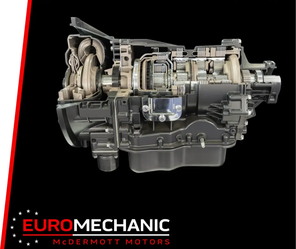 A cutaway view of a car transmission system reveals the intricate gears and structure, set against a black background. The red and white Euro Mechanic McDermott Motors logo is at the bottom left, highlighting its expertise in Transmission Repair Shop services near Bloor West Auto. Euro Mechanic | Bloor West Auto Repair Mechanics | Top Reviewed Auto Repair Shop in Mississauga | Visit bloorwestauto.ca