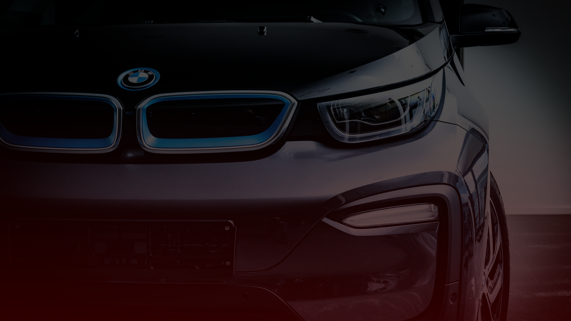 Close-up of the front of a BMW i3 car, highlighting the grille with the BMW logo and one headlight. The sleek design and distinctive blue accents are visible, emphasizing its modern electric features, expertly maintained by a skilled BMW mechanic in Mississauga. Euro Mechanic | Bloor West Auto Repair Mechanics | Top Reviewed Auto Repair Shop in Mississauga | Visit bloorwestauto.ca